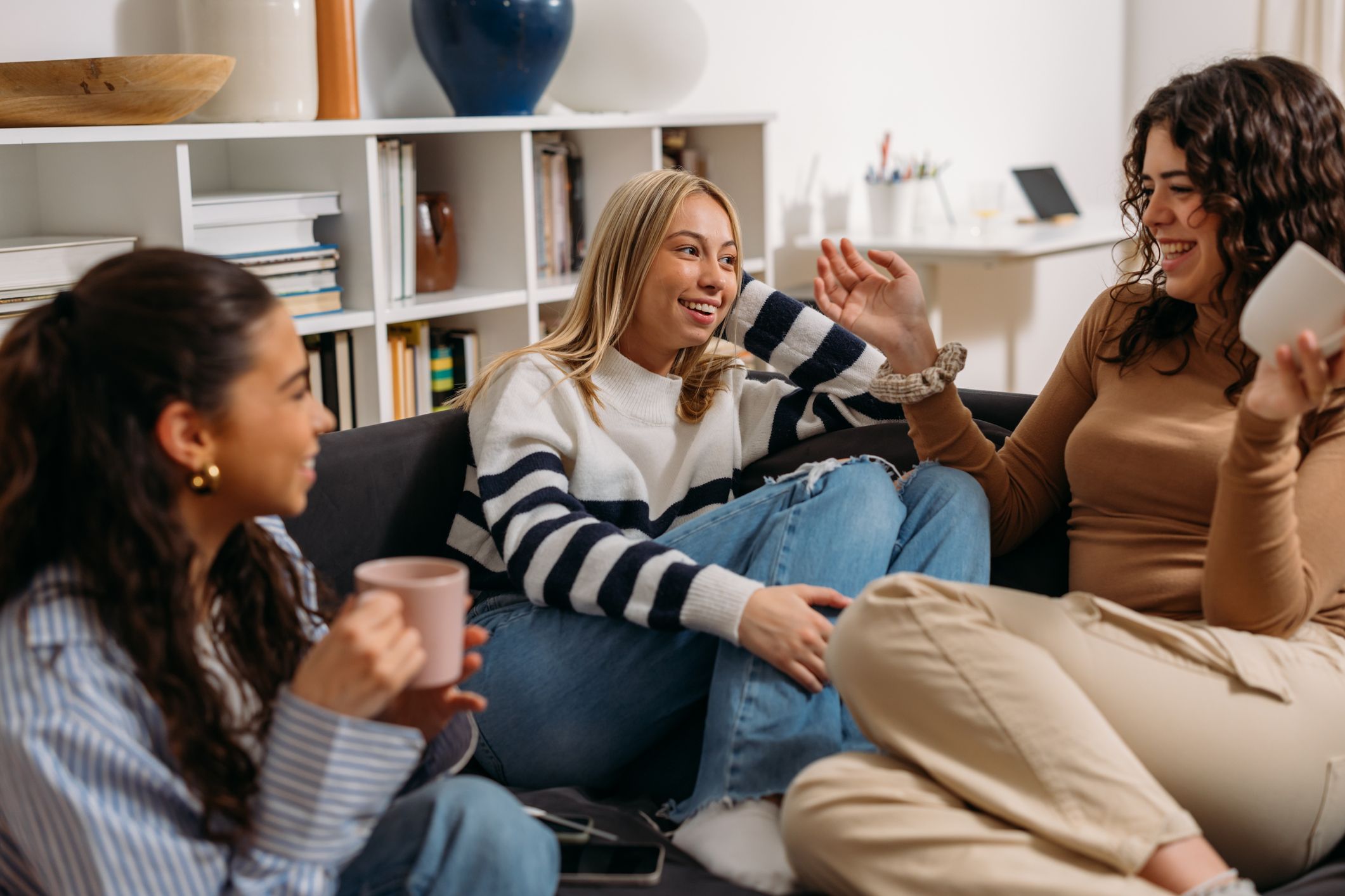 Three friends having coffee together at home