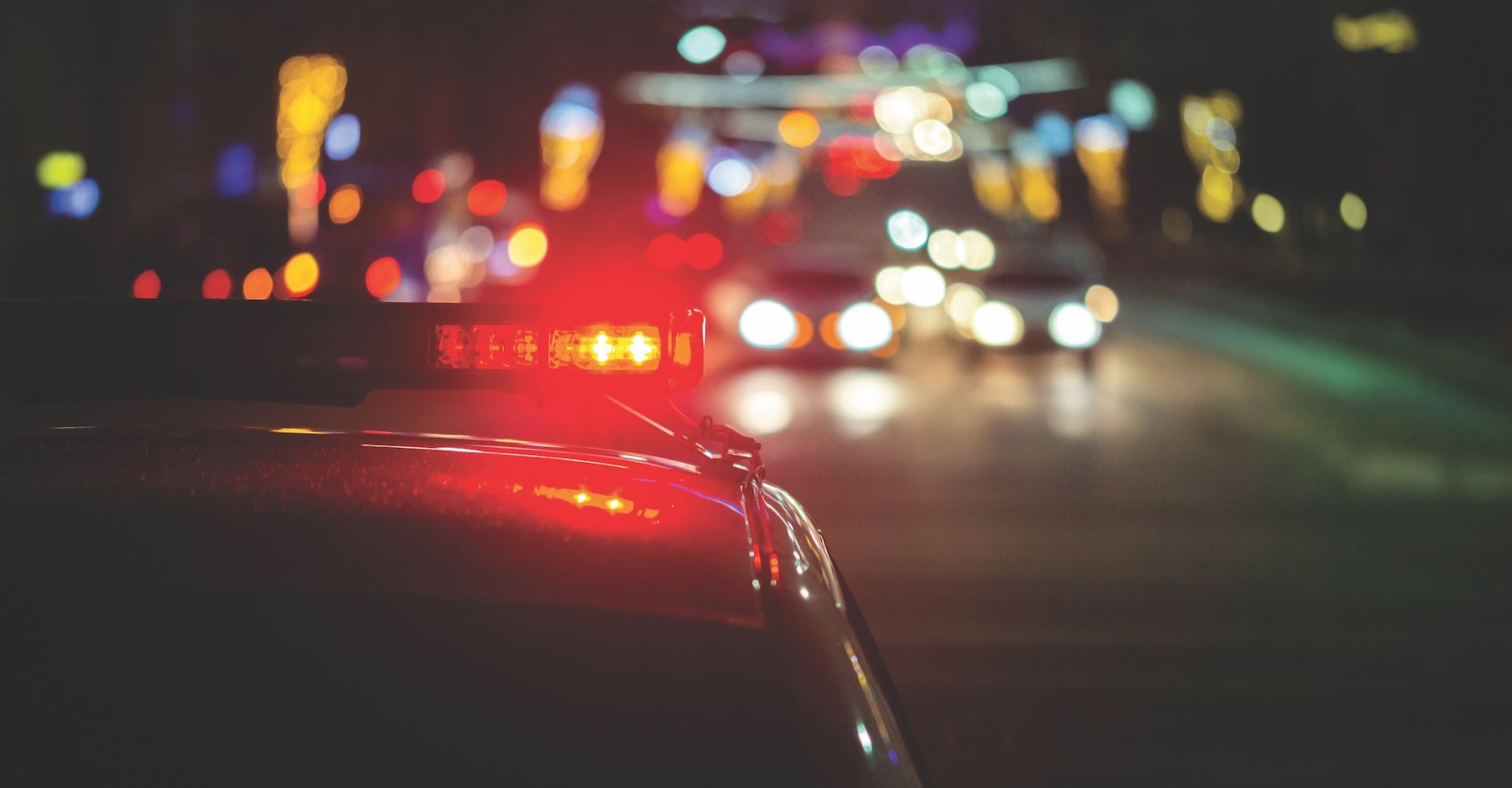 police car lights at night in city with selective focus and bokeh background blur