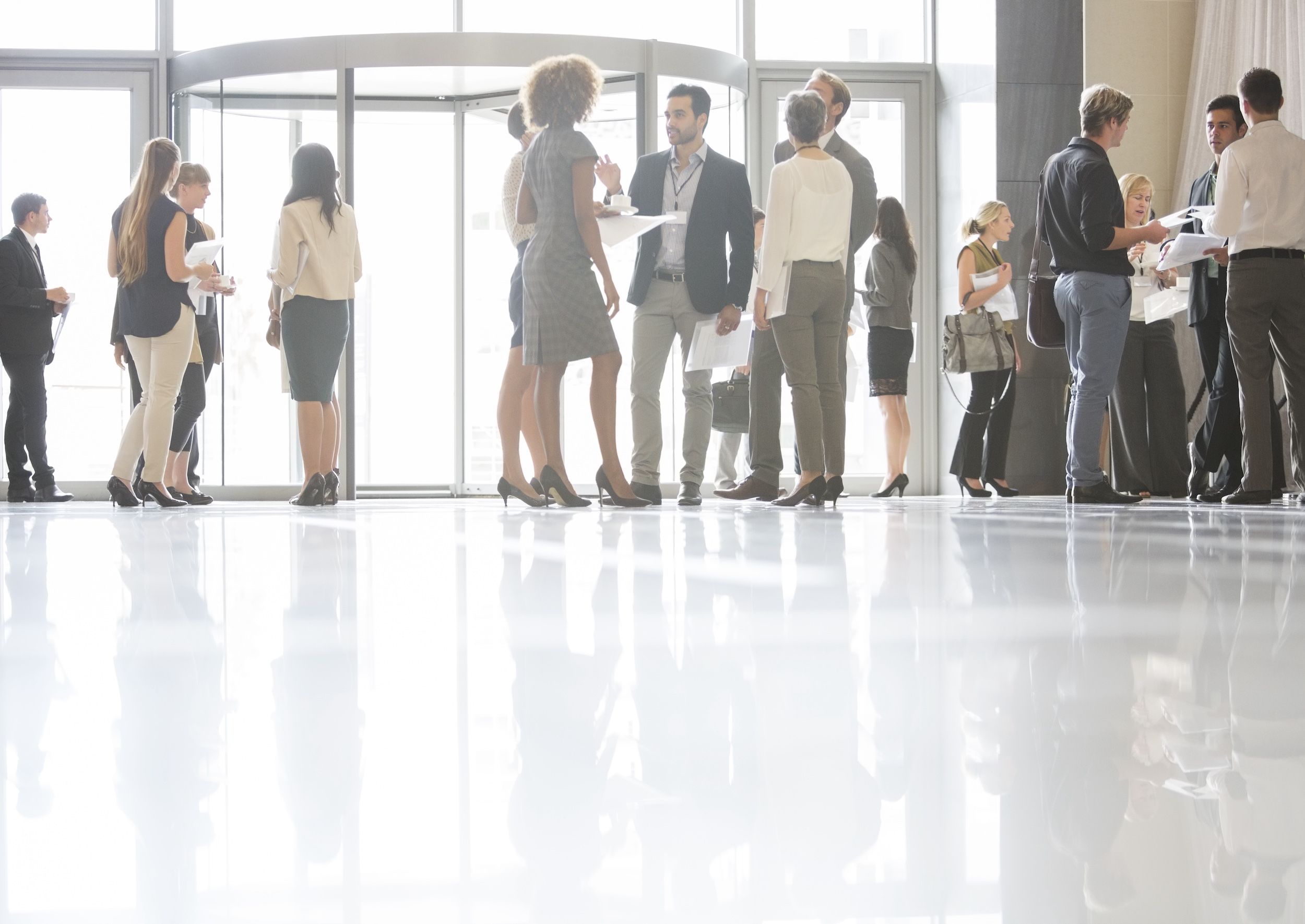 Group of business people standing and talking in office