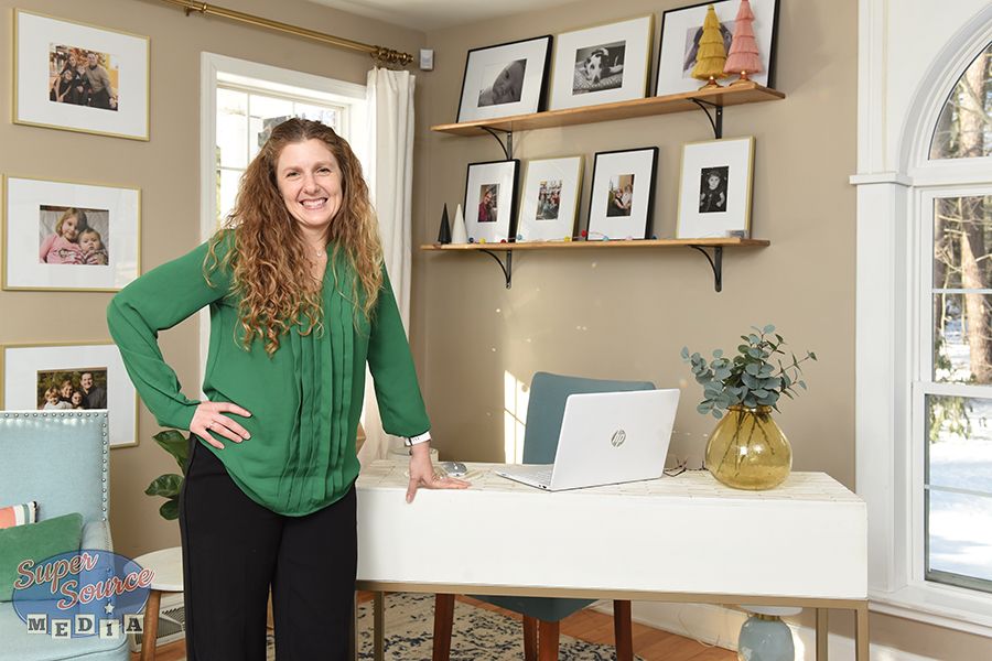 Sabrina Houser standing next to a computer in a green shirt