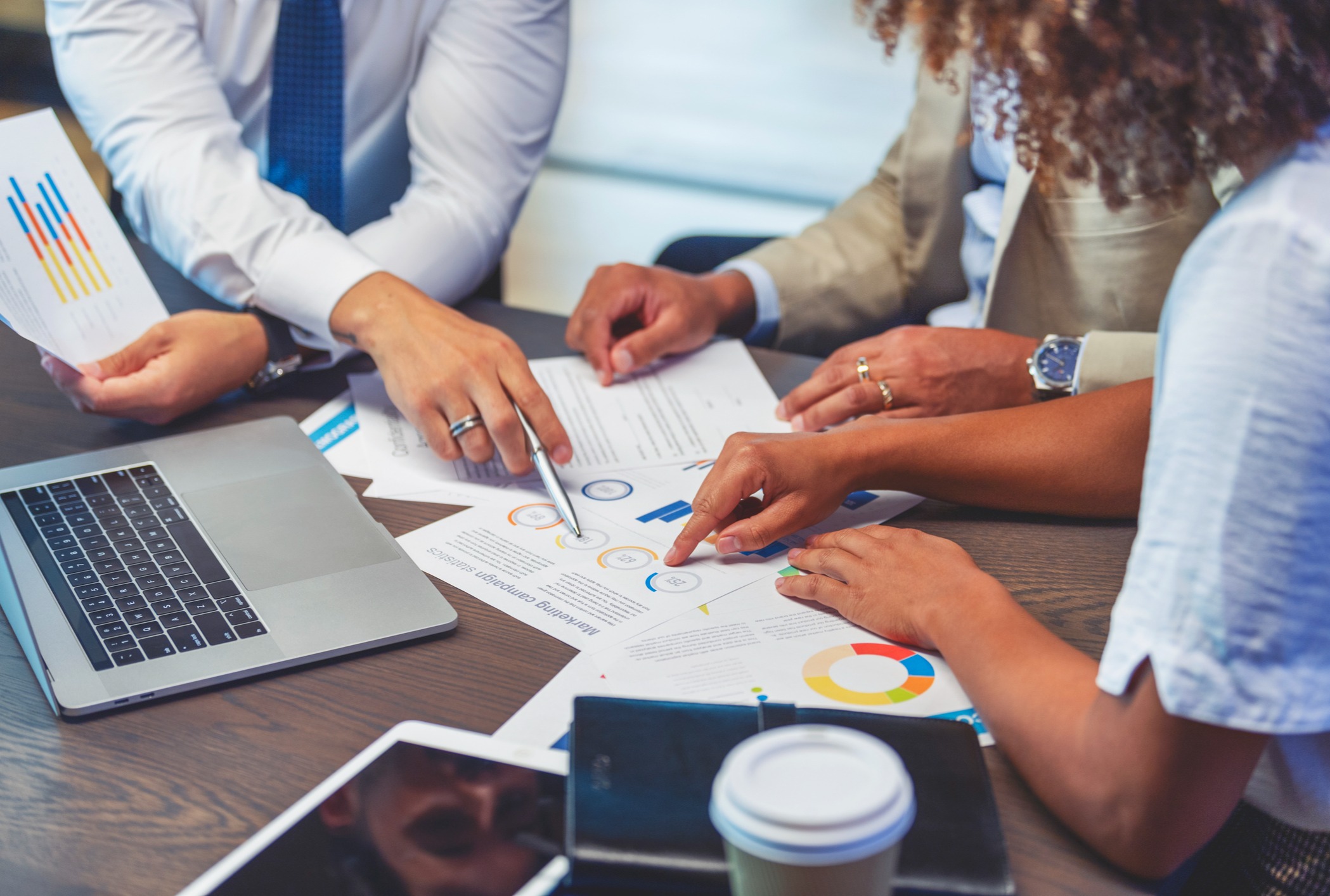 wealth advisors sitting and pointing at various papers on table