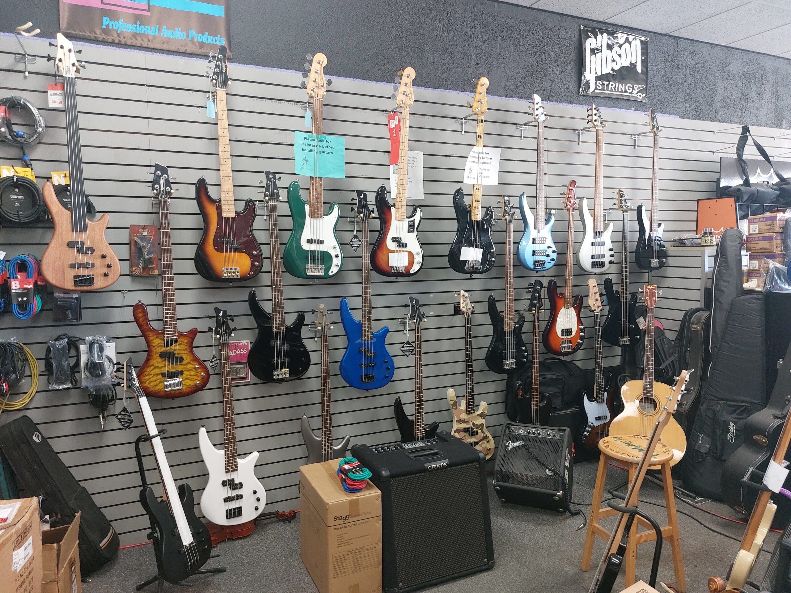 wall of bass guitars