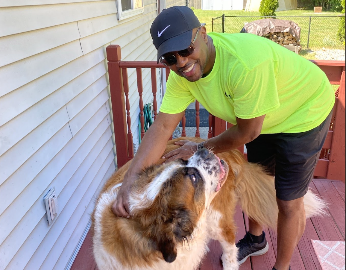 man petting dog
