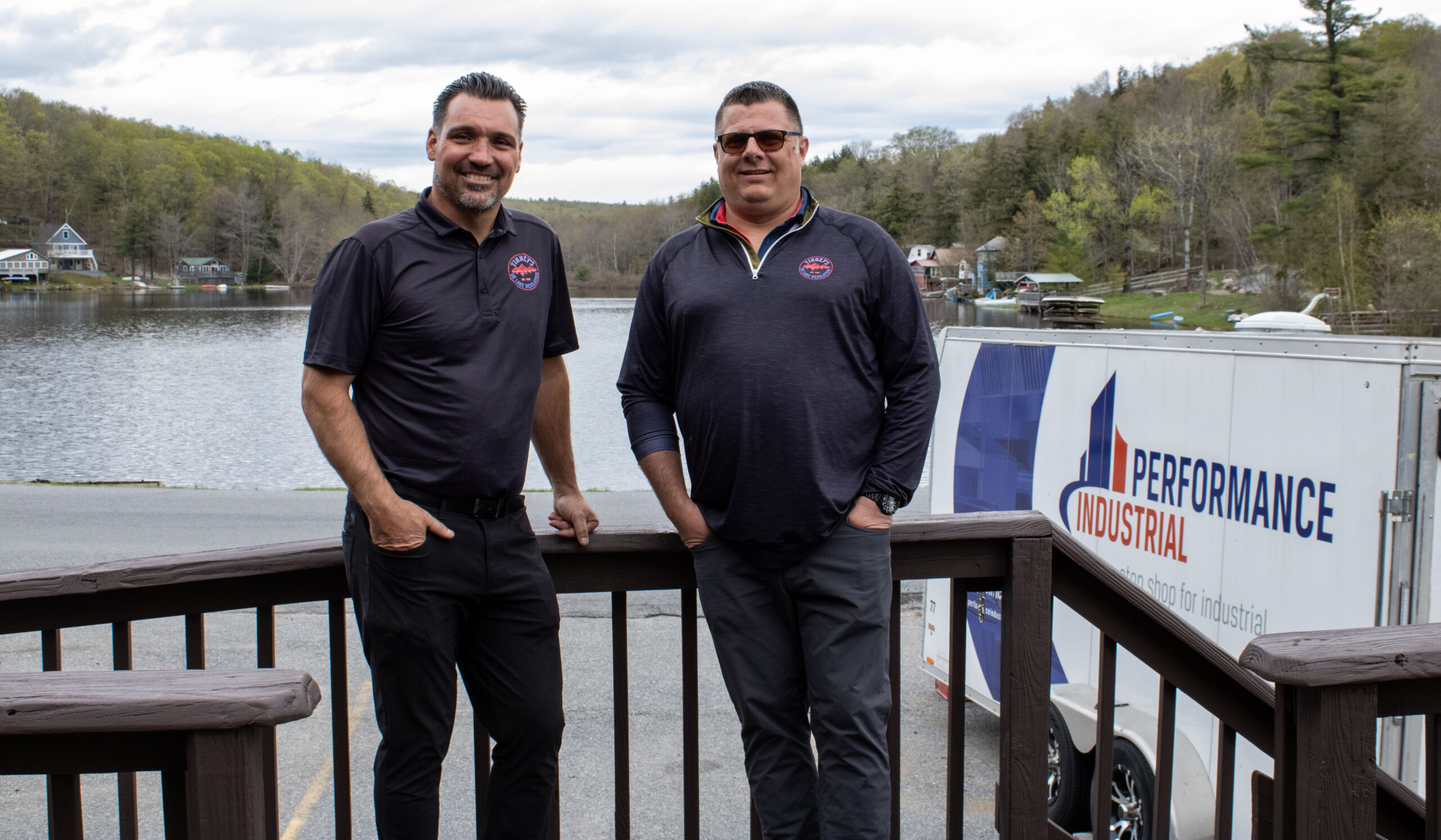 two men in front of lake