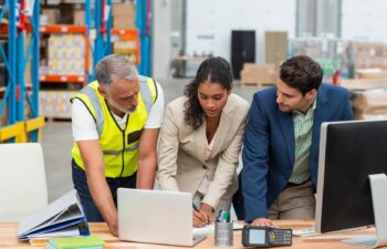 Worker team is working on a desk with computers