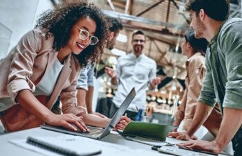 Group of young multiracial business people are working in modern office. Freelancers in coworking place. Creative and stylish youth.