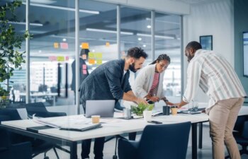 Diverse Team of Professional Businesspeople Meeting in the Office Conference Room. Creative Team Around Table, Black Businesswoman, African-American Digital Entrepreneur and Hispanic CEO Talking.
