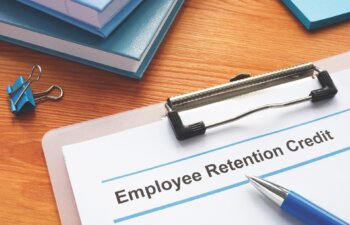 Employee retention credit application and a clipboard.