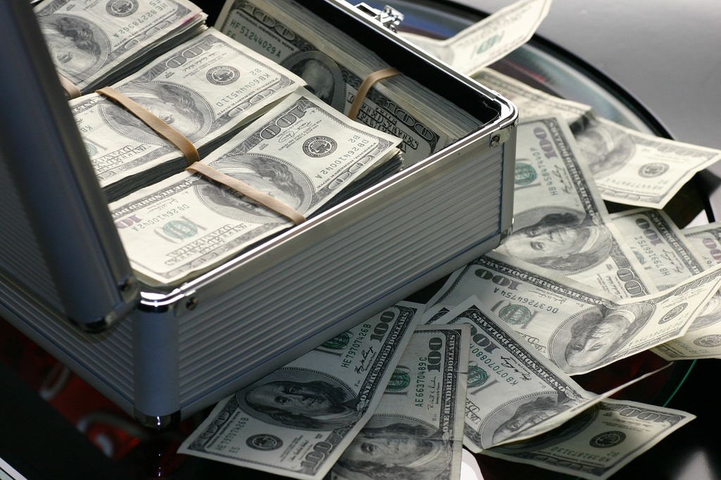 briefcase full of $100 bills overflowing