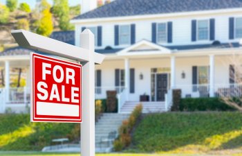 For Sale Real Estate Sign in Front of New House.