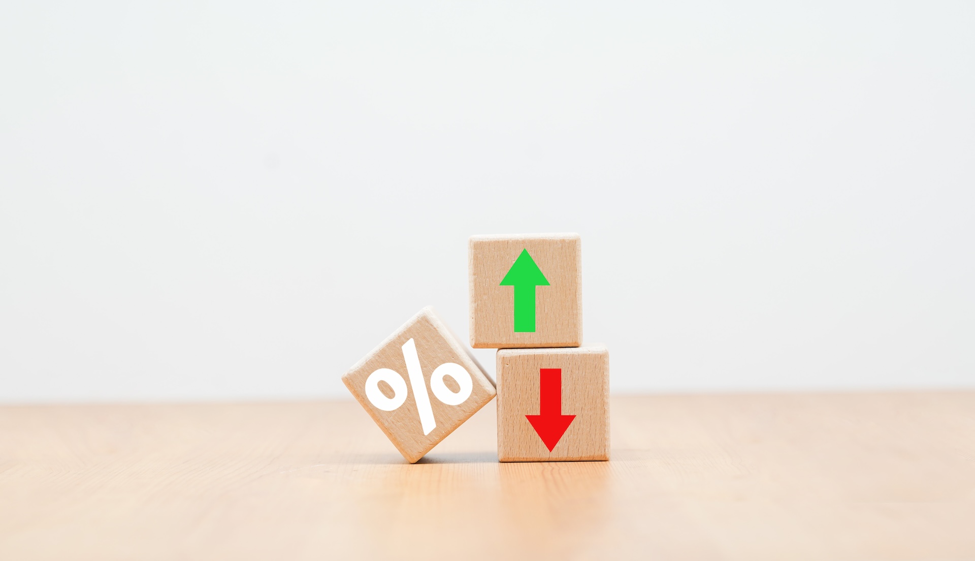 Cube block with percentage symbol icon Interest rate and mortgage concepts wooden cube down and up Interest rates, stocks, business and finance concepts