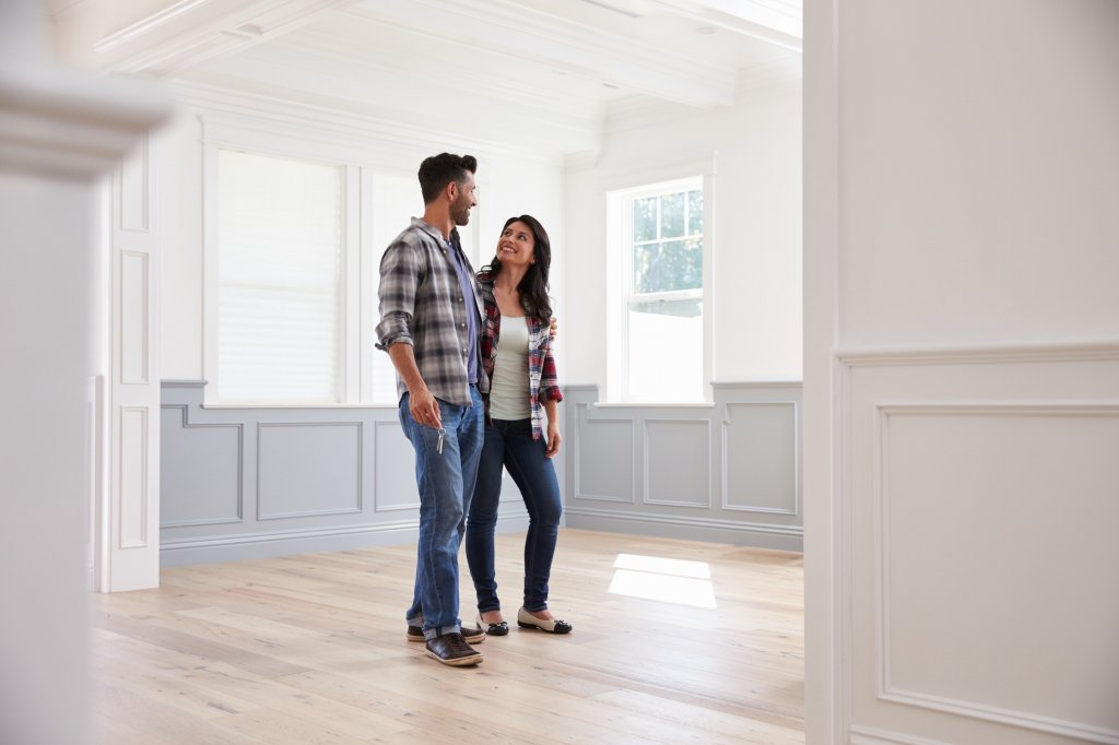Hispanic Couple Viewing Potential New Home