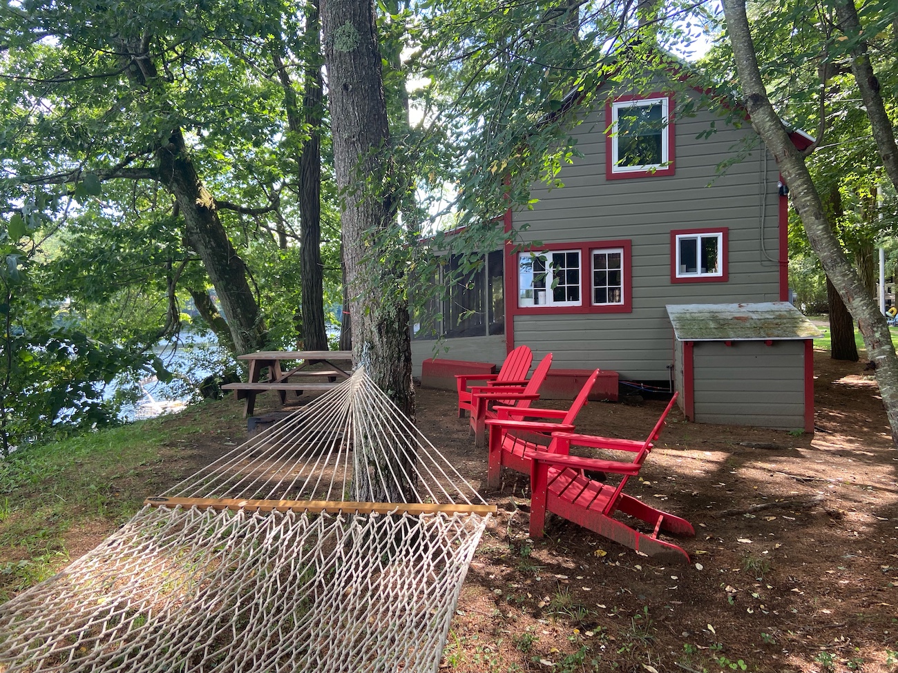 hammock and chairs with side of cabin