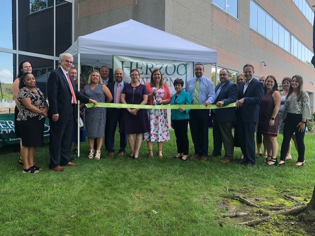 past herzog ribbon cutting