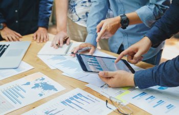 Business team collaboration discussing working with new startup projects, discussion and analysis of business charts and graphs. and brainstorming to strategy planning making a profit of the company.
