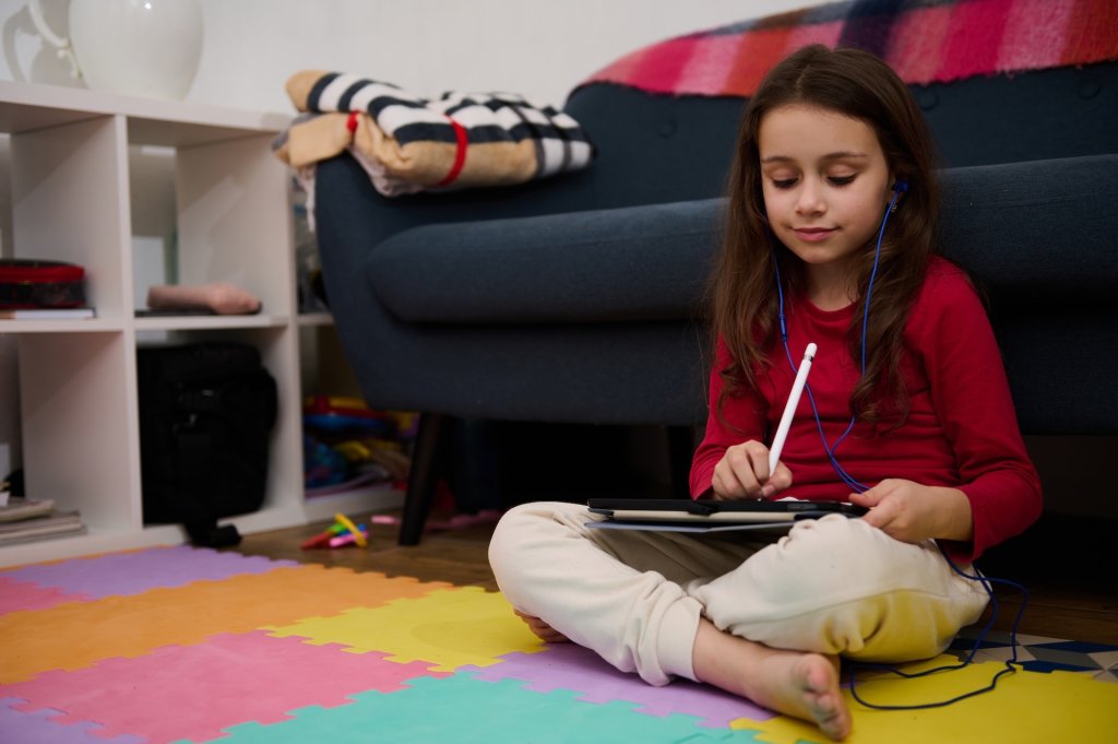 Elementary age student girl in earphones, listening to online class, watching webinar on digital tablet, sitting on multi colored puzzle carpet at home interior. People. Education. Digital technology SSUCv3H4sIAAAAAAAACmyTwY7TMBCG38XnZhXbiRP3hhaExGmlPW5QNbHd1mwSR46z7FL1wIvwDFyQ9oJ4hfJGTNxGLZRTJr/tmX/Gn3ekhsEqstwR2zTjEDwE6zqyTBfEm04bH8Mnz0UaI7DxY7QNzlto4l8NQW07aA1ZdmPT7BdkCBDGwQxTYtCuNkNw6pEs6YL09jlAjCjjfh2jYTuGYPx5k/YG2iHYKSXHM67TeVyABtqXGL3AS2uVd3FD64bQb11wQ1z74lwH/pjJ9G6w50U0pyCYDbo/2jsN4GE36WRJCNoZ6ynYL/6jfUQPG9MpNLHbYzJvGgOx0wdCTQ5FbmRSMy2STNQqqZXWSaFrViqRQw0CU+W6AJ1xmqga8iSruUxkKteJELnK65JqkVKCdR4/40zaySTWgVFb7HVHnpyCBkU+ibYHD/OW3ltlu83xx4XtdHnYgRu74NEuYVRi9ca5HuoGB7vGPGZBtjAMuEefhGlACIJrj3k6F6bmphFonBtGlPO8lAUvmUwZyyhnZL7wrcWDU60dGfvGgTb6ioCCZlkpc5GdUZgleWbiJBXpFRzzivybklkvL3A5STI7c3OURMouAZpVmv9D0qzLC6ROWpZeszUtyRyfyvQCxrq16DsO4MqopEyUVxYk5SmfoIq9Wh35vDxLOBV5lmKXOPLzYYItClGIEpElFiuSdWFqlQmT5BllSWaYSiQUZUILLUExTg0vMMXxksLEFZ5cO99G3D0MOPDICrLWQ9iieLusqsO3w6/D6++vh++Hn4fXw4+qYiUykLJs9UabZnUfkNJug/LNXRzK6sPd+9W75975UFW0qt7e3654xuTNp35D9n8AAAD//wMA9xwF8H4EAAA=