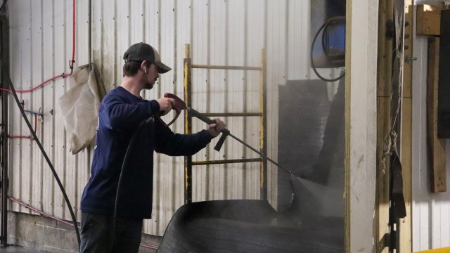 man spraying tires with water