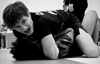 two kids fighting in black and white