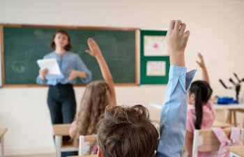 students raising hands