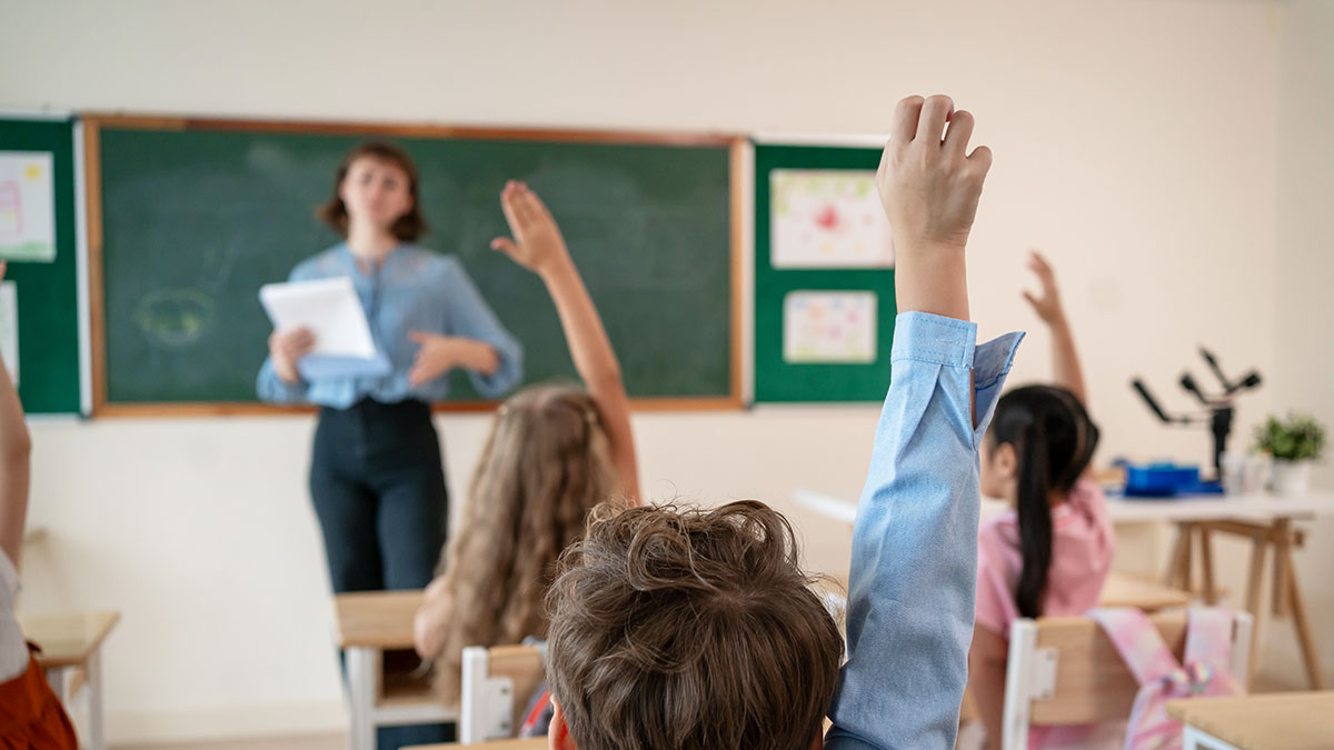 students raising hands