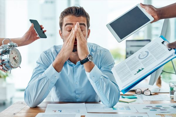 Portrait of a young businessman looking stressed out in a demanding office environment